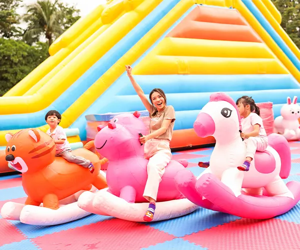 Happy children jumping and playing in a large inflatable area
