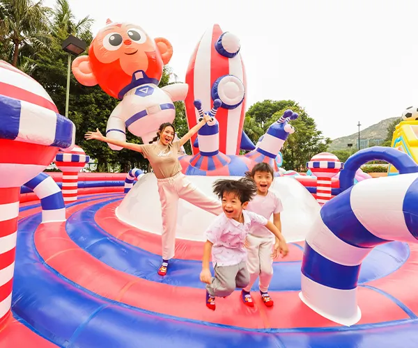 Kids interacting with a themed inflatable character or structure