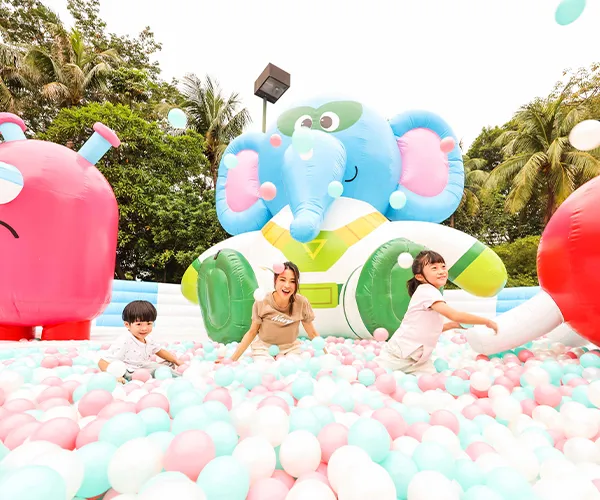A group of kids laughing and playing in a bouncy castle