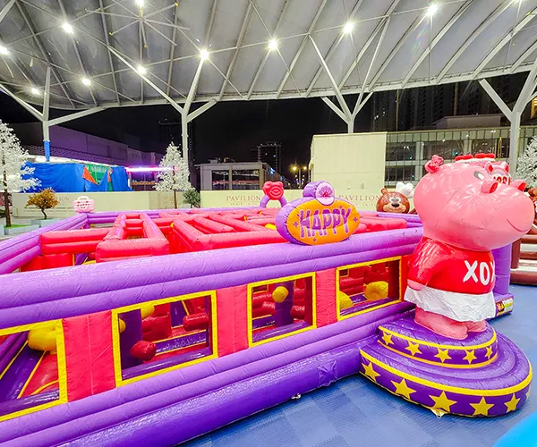 Kids smiling while playing in a bright inflatable area